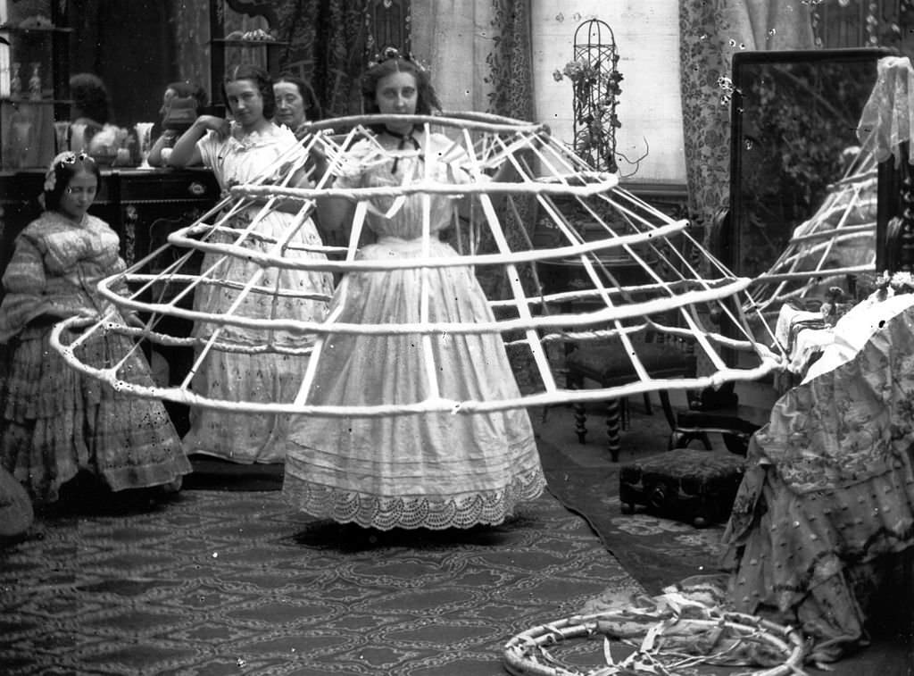 The scene from a ladies dressing room, preparing for the crinoline, 1860