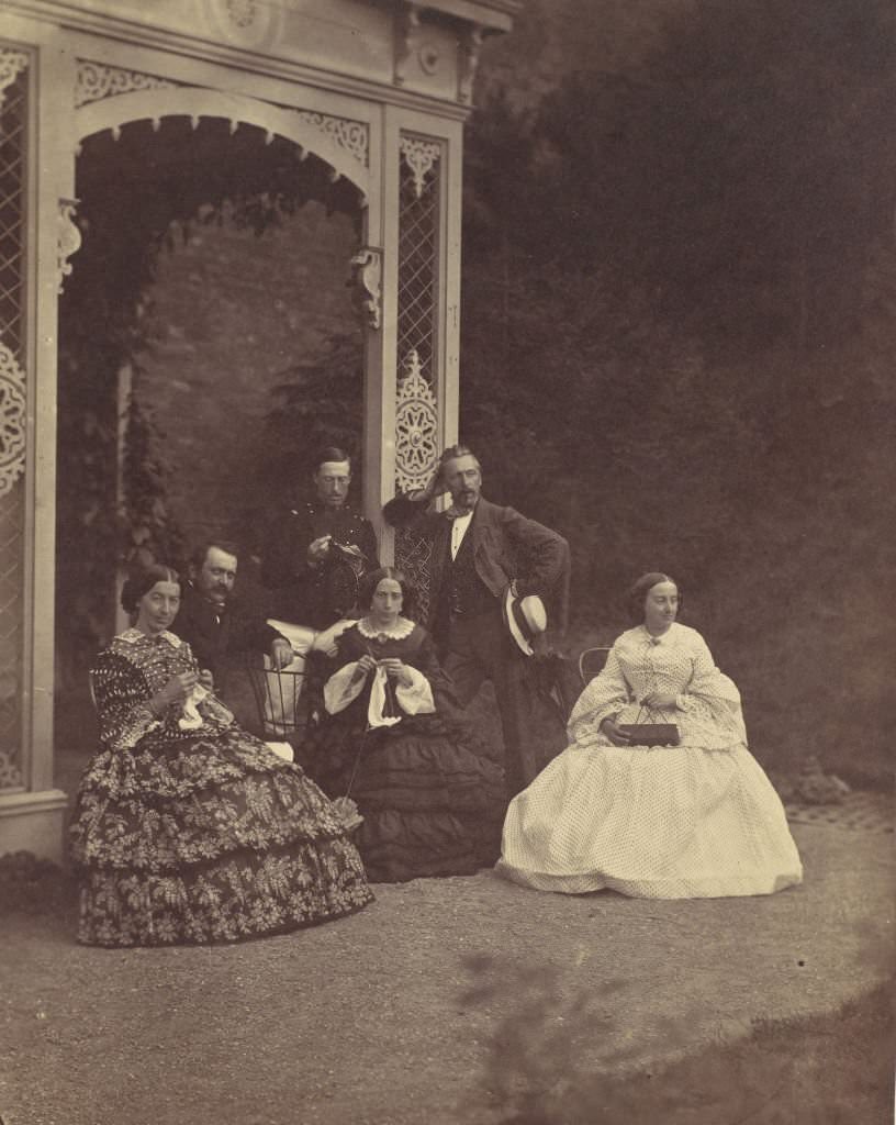 Three Women in crinolines and men in a Garden, 1850
