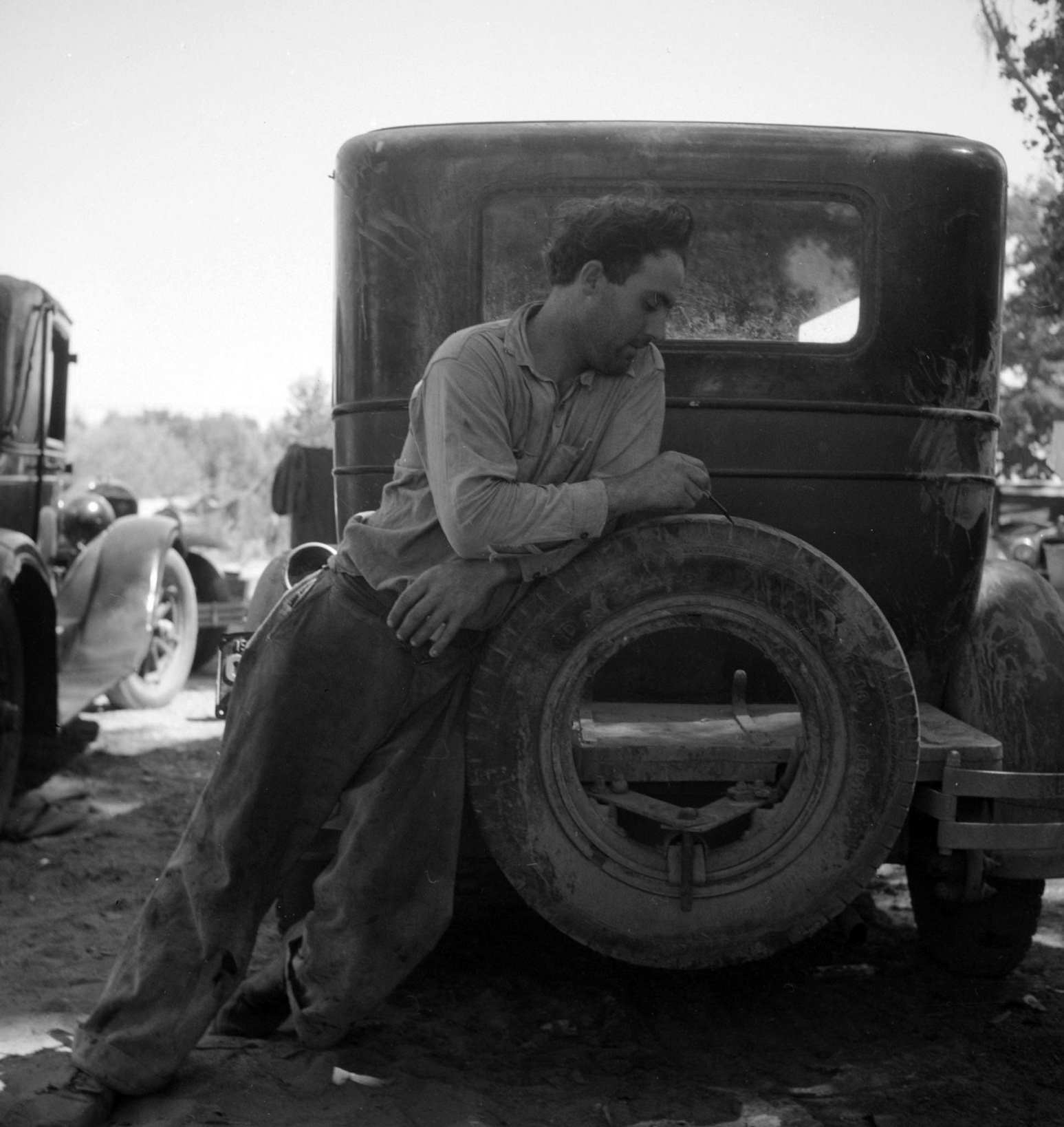 Migrant agricultural worker in Marysville migrant camp (trying to figure out his year's earnings). California, 1930s