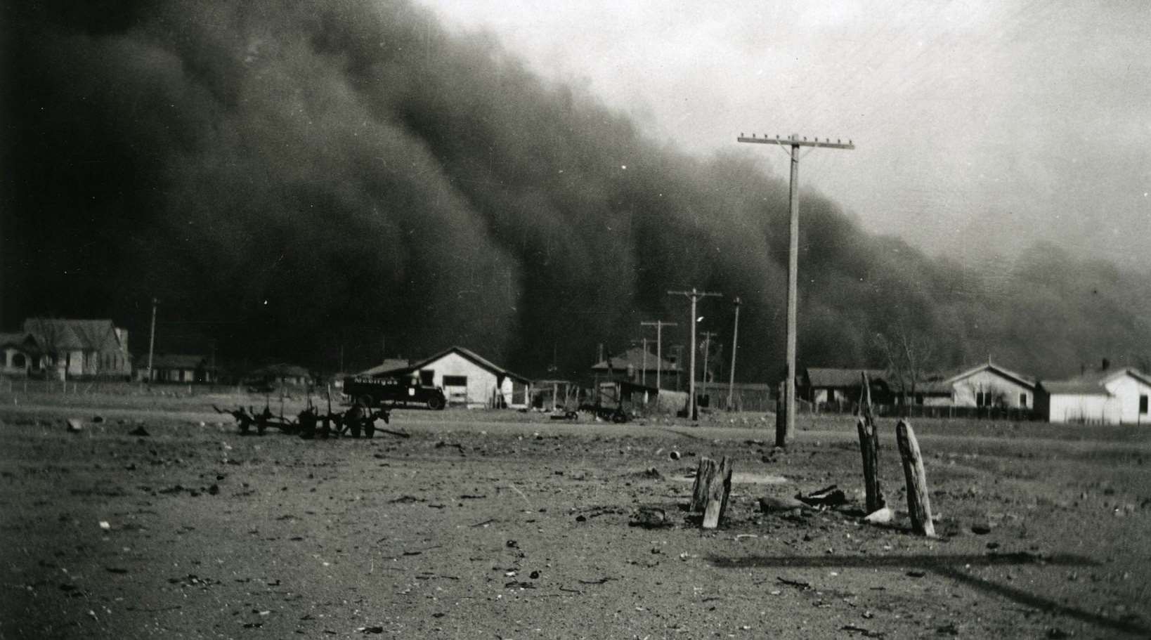 Huge dark dust clouds swarm over houses in rural Colorado, 1930s