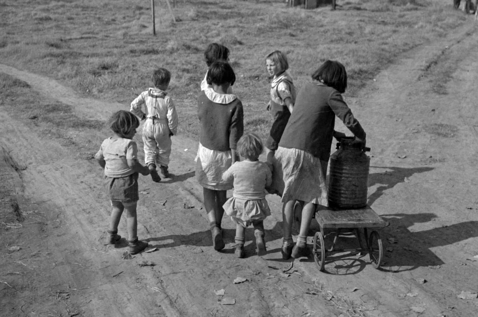 Children of migratory workers, hauling water, American River camp, San Joaquin Valley, California, 1930s
