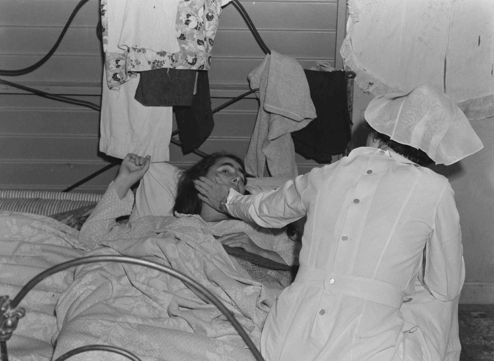 Nurse with patient at a Farm Security Administration camp for migratory agricultural workers at Farmersville, 1938