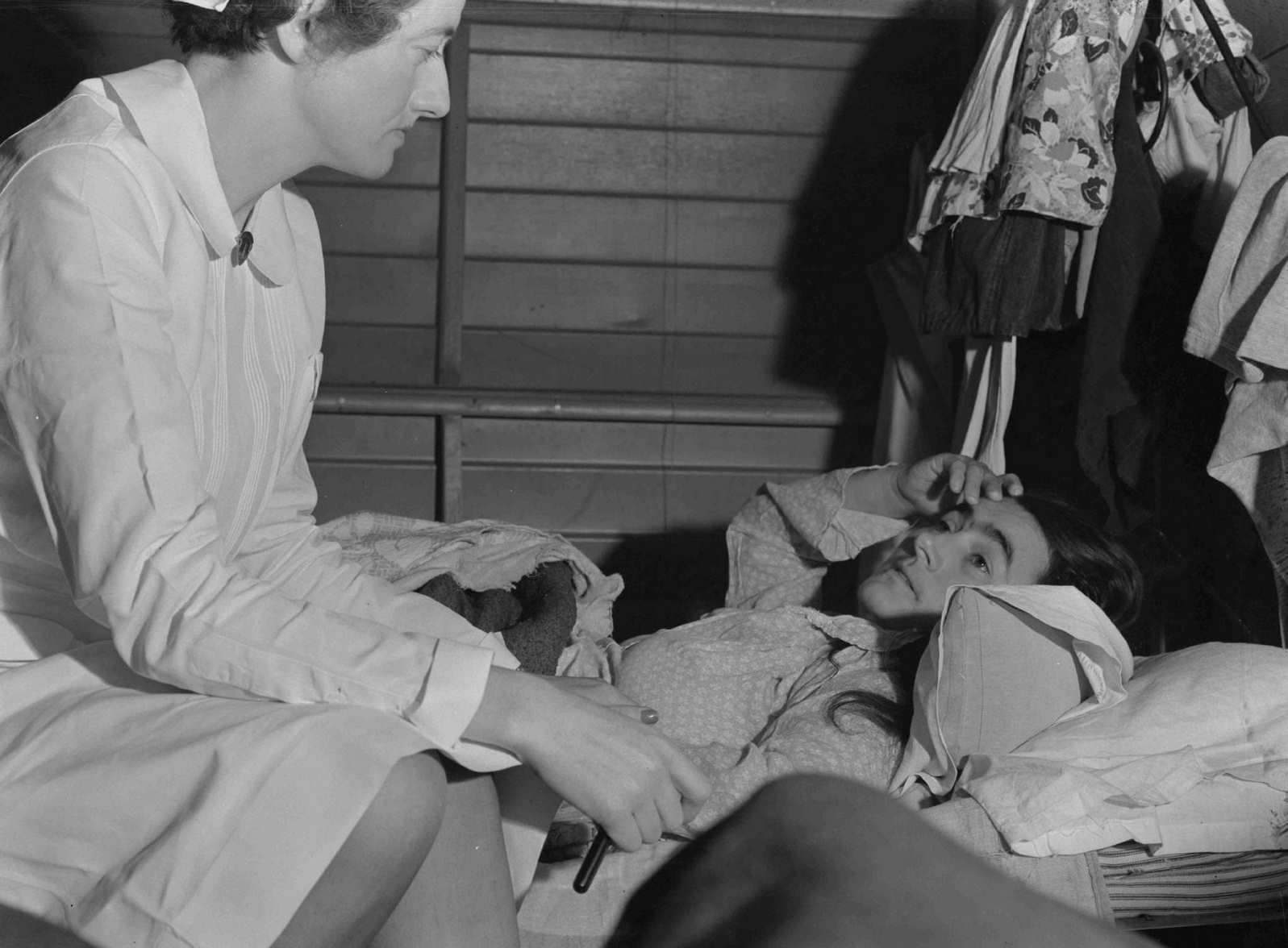 Nurse with patient at a Farm Security Administration camp for migratory agricultural workers at Farmersville, 1938