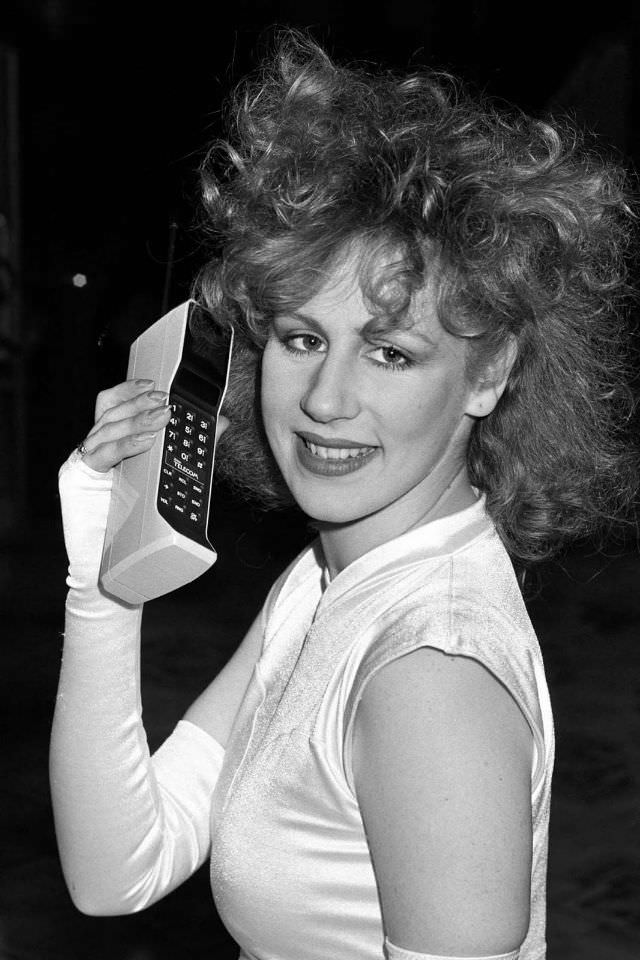 A model poses with a phone at the launch of the Cellnet cellular radio system mobile phone service in London,1985.