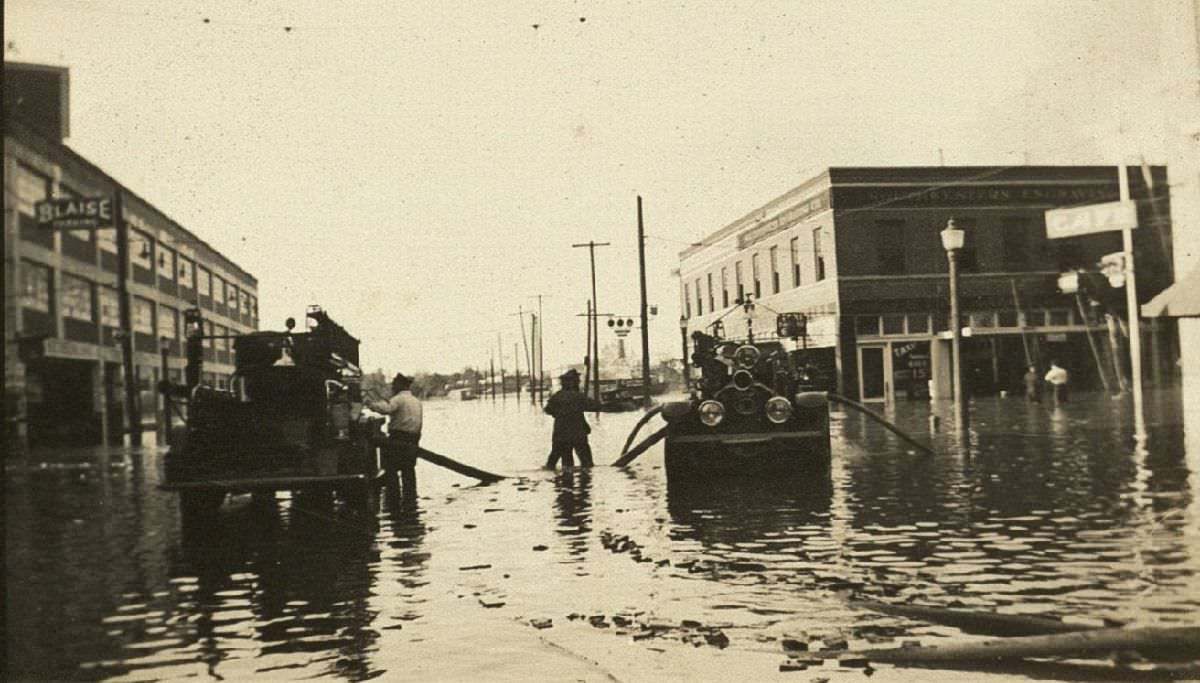 Firefighters on flooded street, 1935