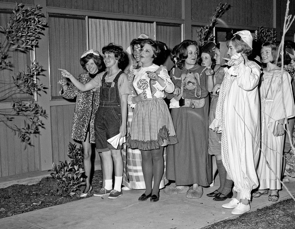 A bunch of co-eds having a costume party at a near-by women's dorm, walked over to serenade at the neighboring men's dorm, 1964