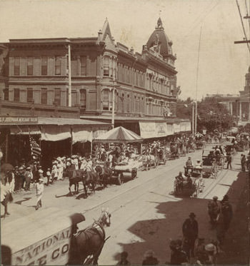 View of parade along Mariposa Street in Fresno. J & Mariposa St. Fresno Cal. No. 20., 1890