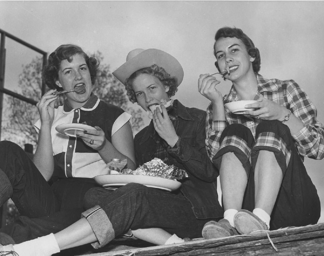 Three students eating, 1953