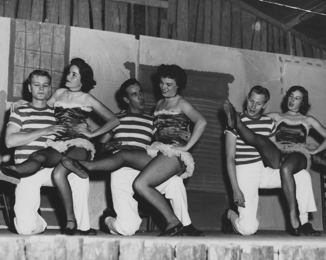 Students perform can-can on stage, 1950s