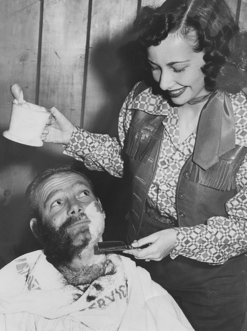 Student shaves a man's beard, 1950s