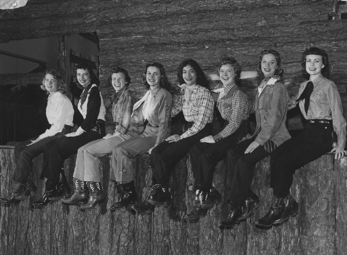 Students sit on a wooden ledge, 1950s