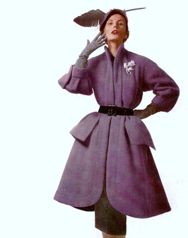 Jackie Stoloff in purple woolen coat, belted over gray skirt by Jacques Fath, photo by Philippe Pottier, 1951