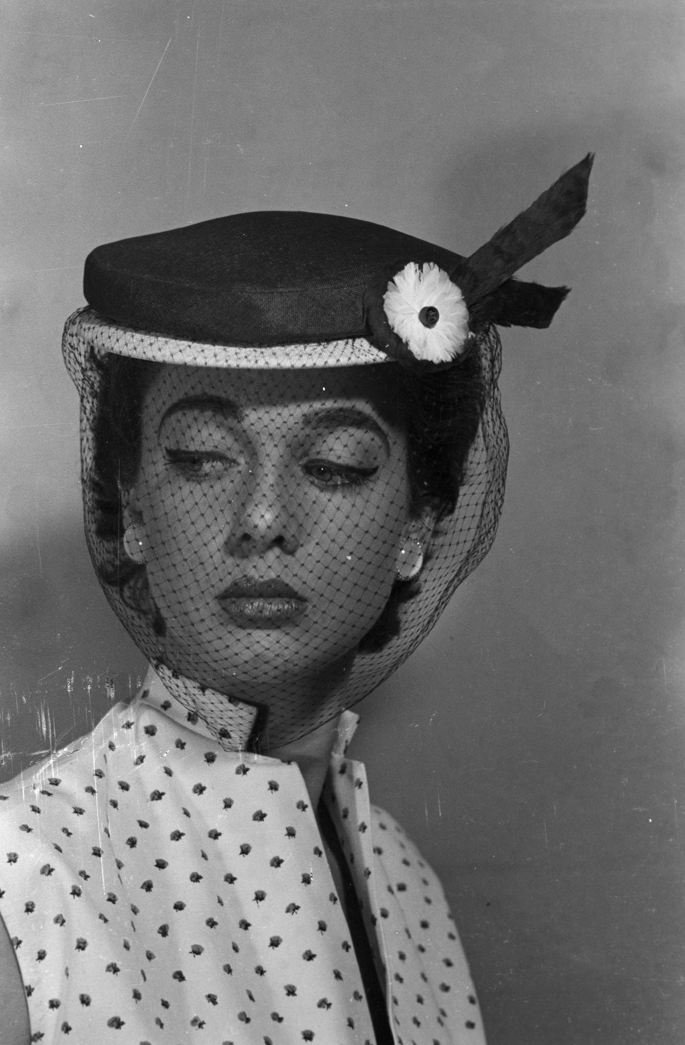 Model presenting hats of spring by Jacques Fath, 1953