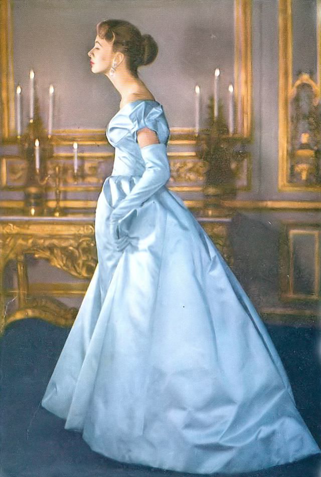 Suzy Parker in ball gown of blue satin with intricately seamed bodice, back-swung and bow-knot sleeves by Jacques Fath, Vogue, Novermber 1, 1953