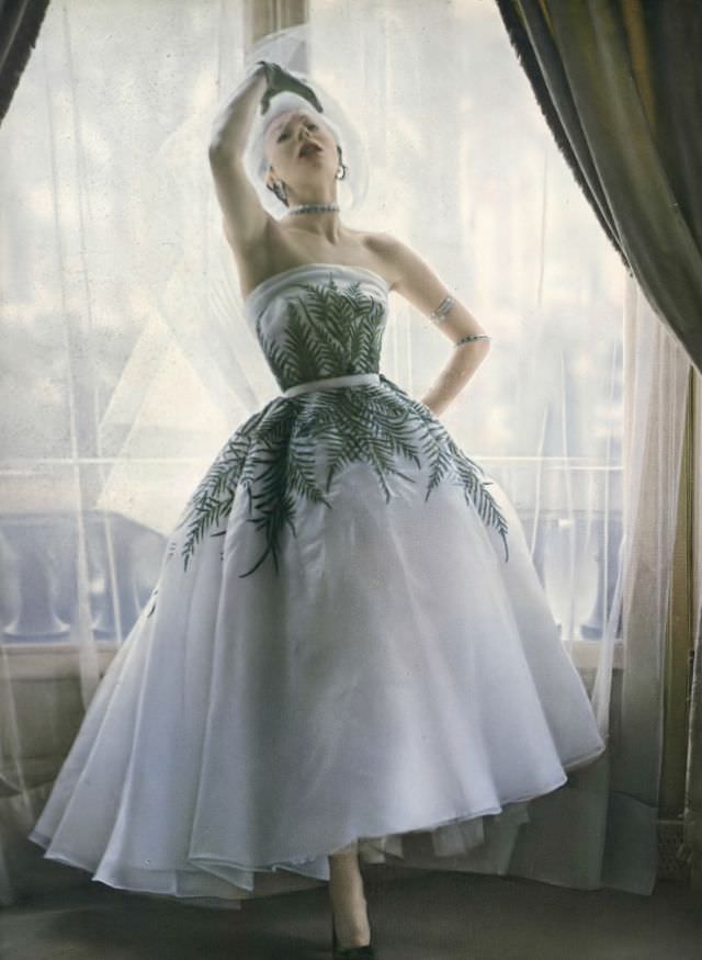 Bettina in evening gown with fern leaf motif by Jacques Fath, Vogue, 1950