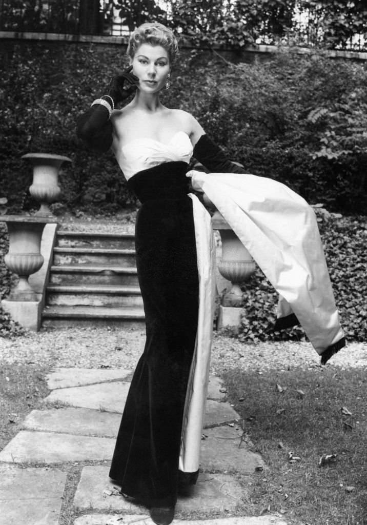 Evening dress in black velvet, white satin belt, for winter 1953-1954. Created by Jacques Fath, Paris on August 21, 1953.