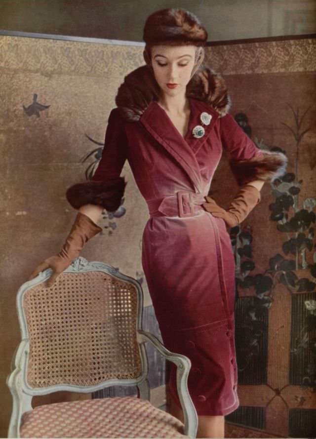 Sophie is wearing exquisite faded rose velvet coatdress trimmed in mink by Jacques Fath, veiled mink hat, jeweled clips by Roger Scemama, 1950