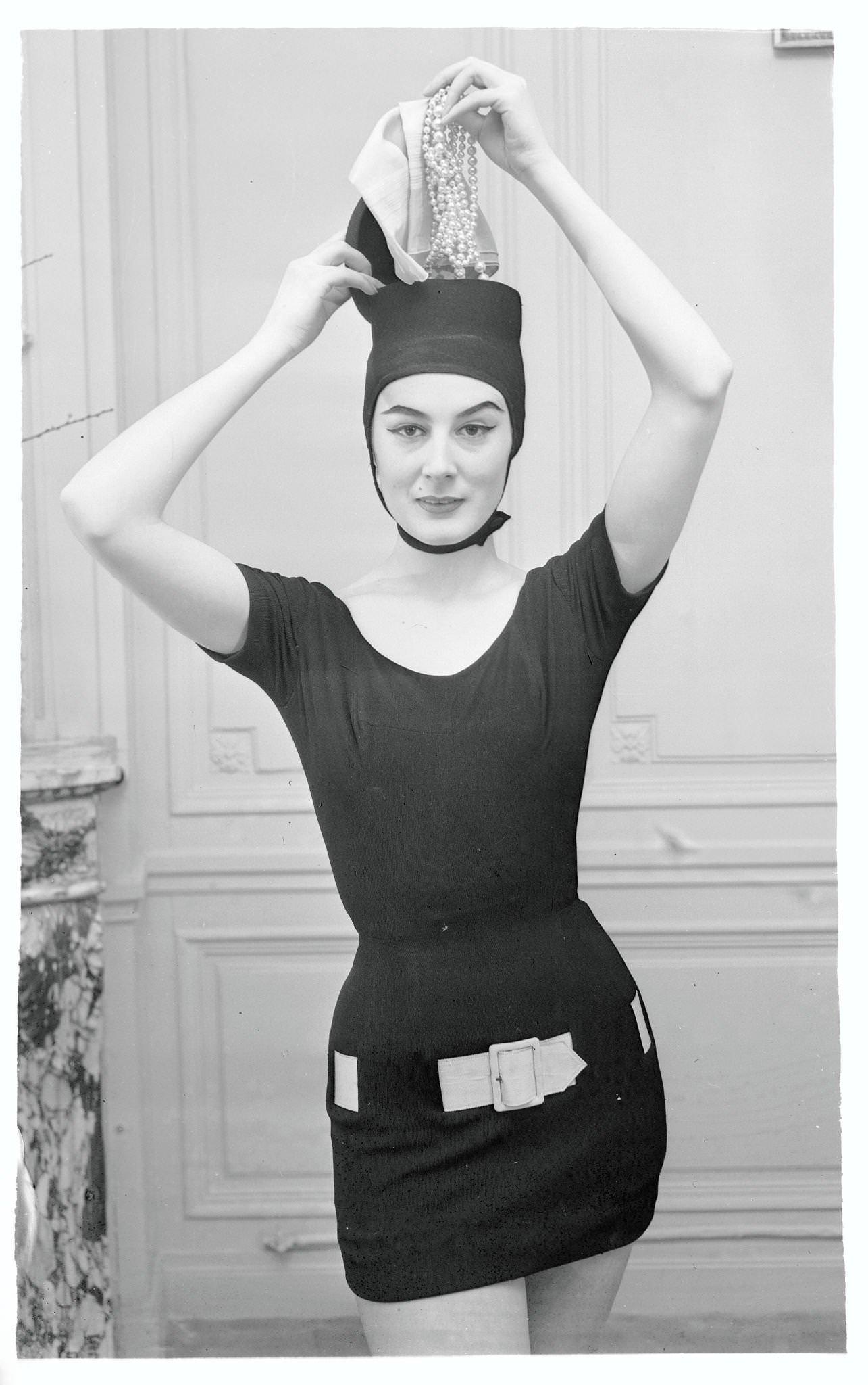 Model in Beach Suit and Reaching to Her Unusual Hat