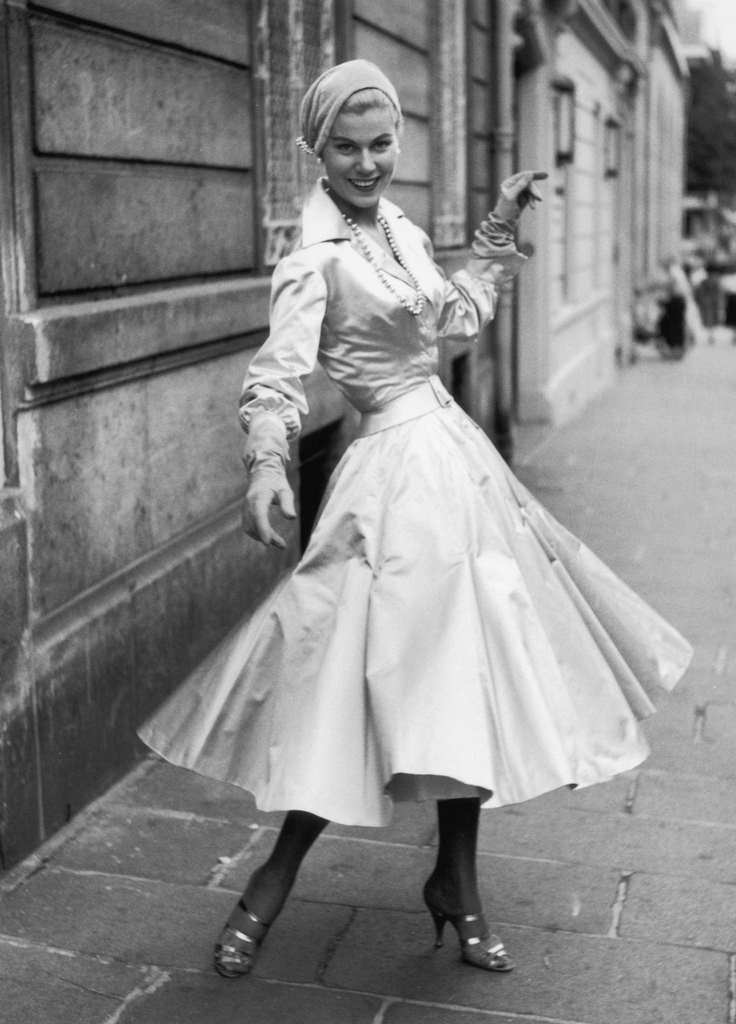 A cocktail dress and waist length fitted jacket in cream satin made by Jacques Fath, September 1954.