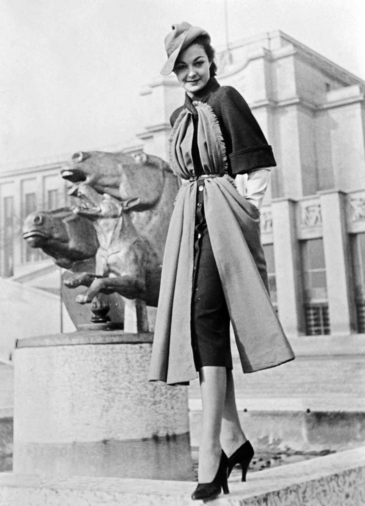 Afashion model wearing a clothing created by Jacques Fath.