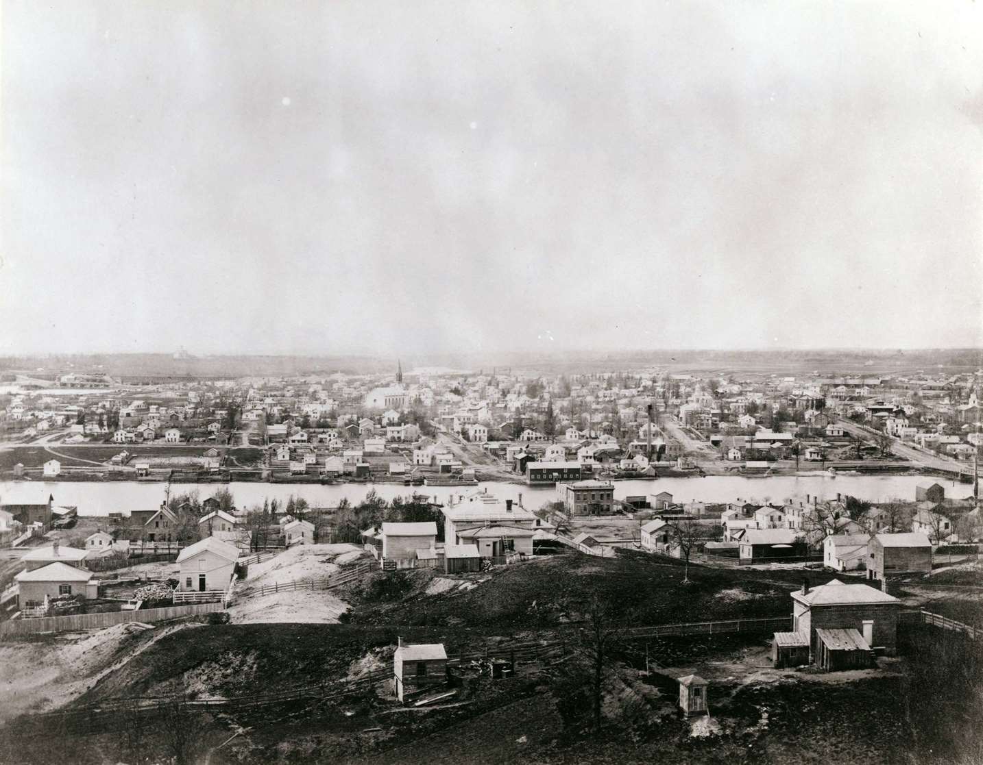 Elevated view of Janesville with a residential area in the foreground and the business district in the background, Janesville, Wisconsin, 1860.
