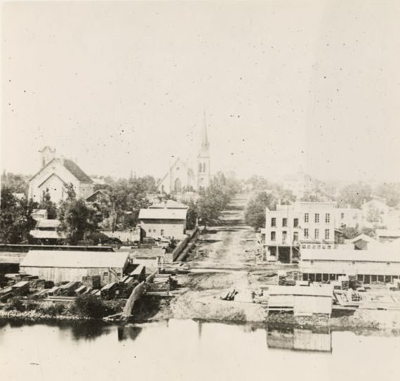 Elevated view over river of Dodge Street in Janesville looking west, 1870