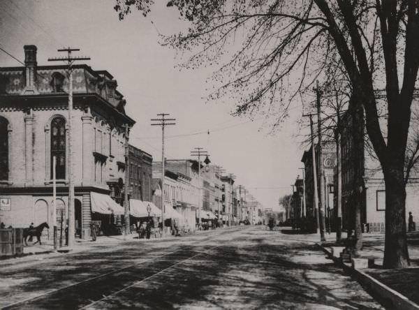 Looking northwest from the Methodist Episcopal Church, Main Street, with trolley track running down the center of the street, 1893