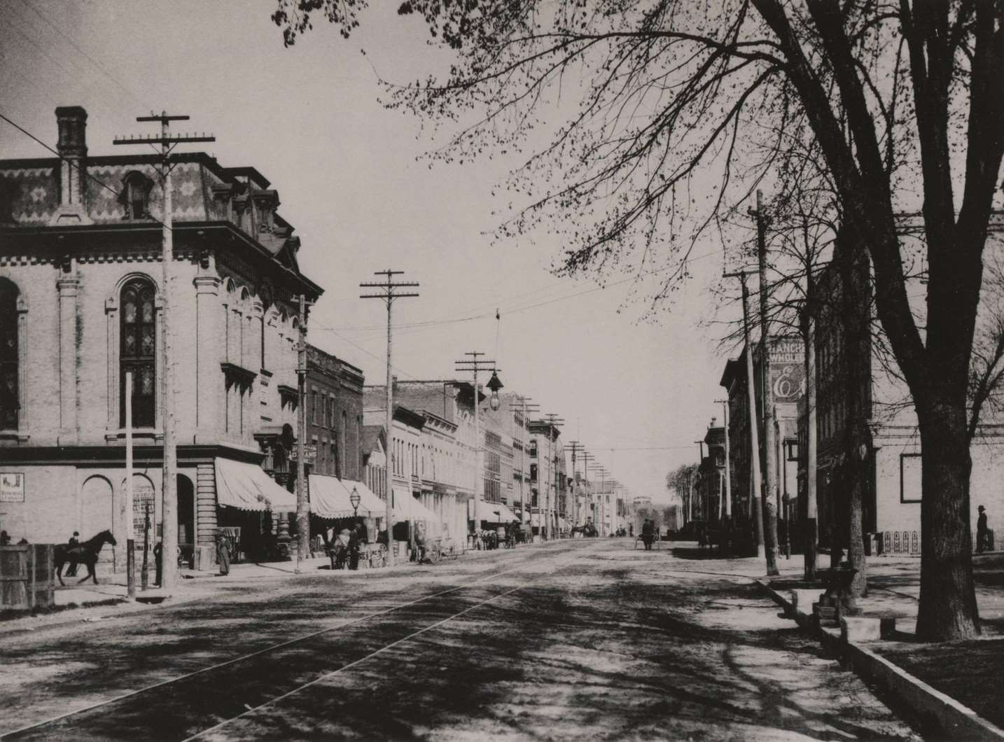 Looking northwest from the Methodist Episcopal Church, Main Street, with trolley track running down the center of the street, Janesville, Wisconsin, 1893.
