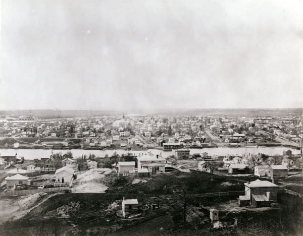 Elevated view of Janesville with a residential area in the foreground and the business district in the background, 1860
