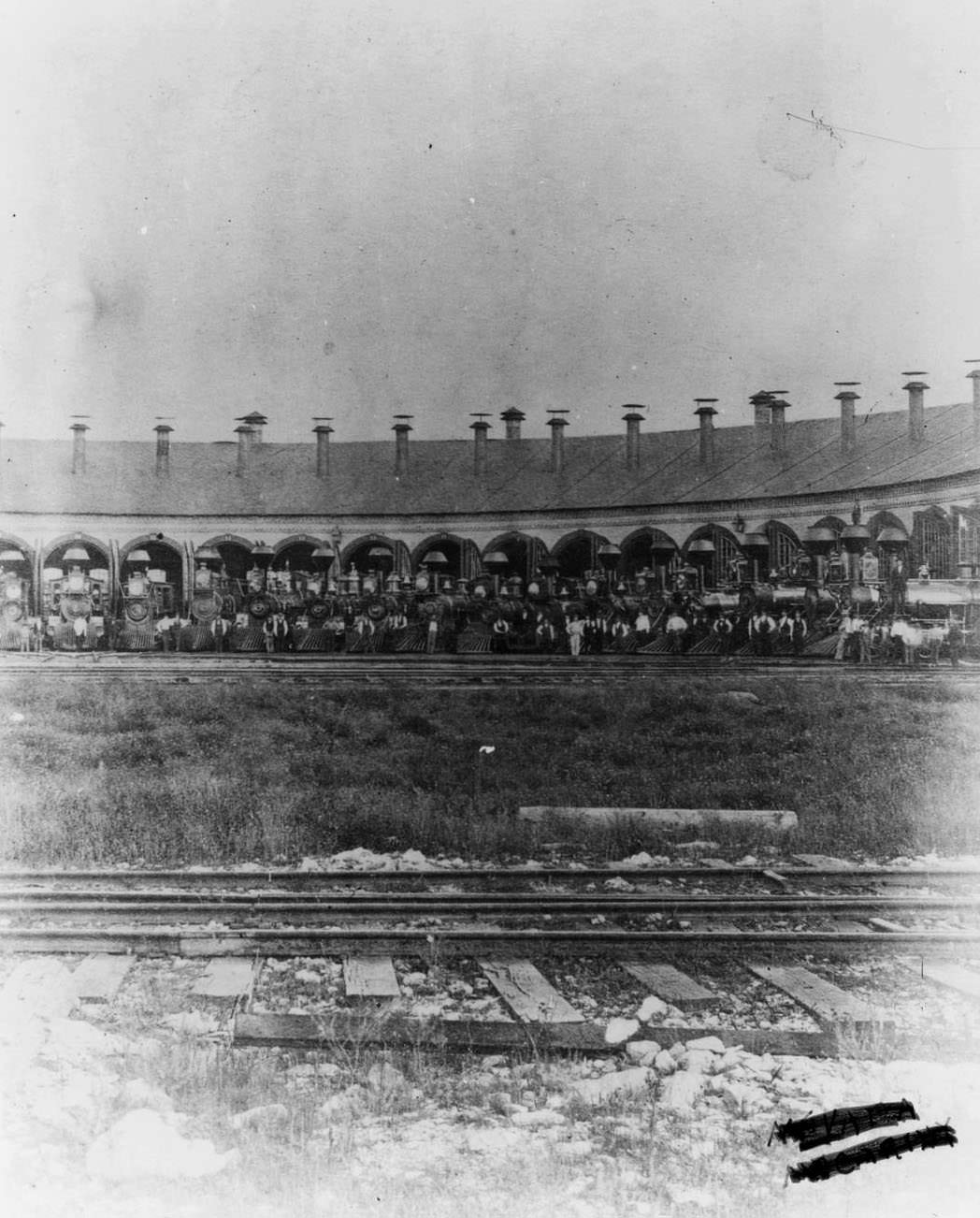 Railroad roundhouse with wood-burning locomotives, 1860