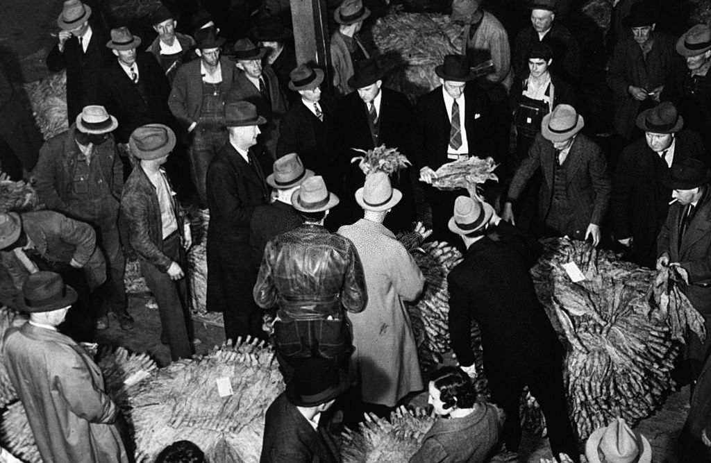 Auctioneers, buyers and farmers at a tobacco auction sale in Durham, North Carolina, November 1939