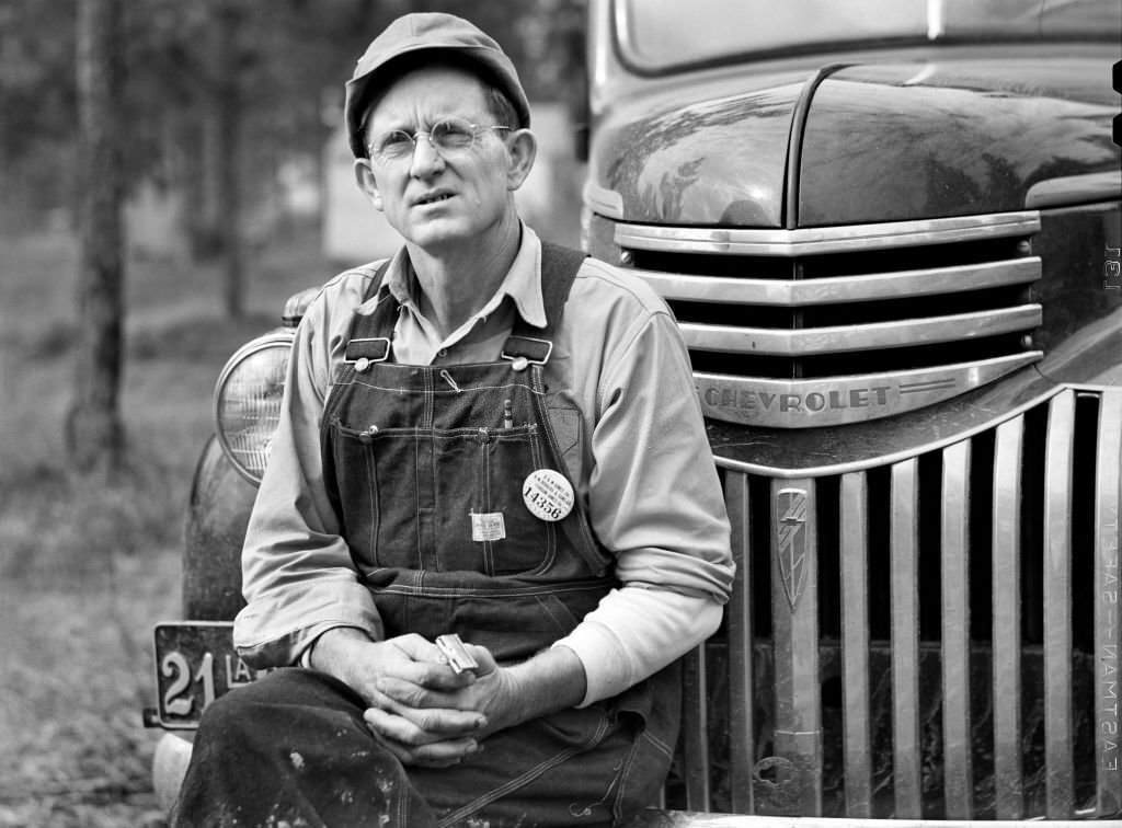 Construction Worker sitting on Car before leaving for Evening Shift, Camp Livingston, Alexandria, Louisiana, December 1940