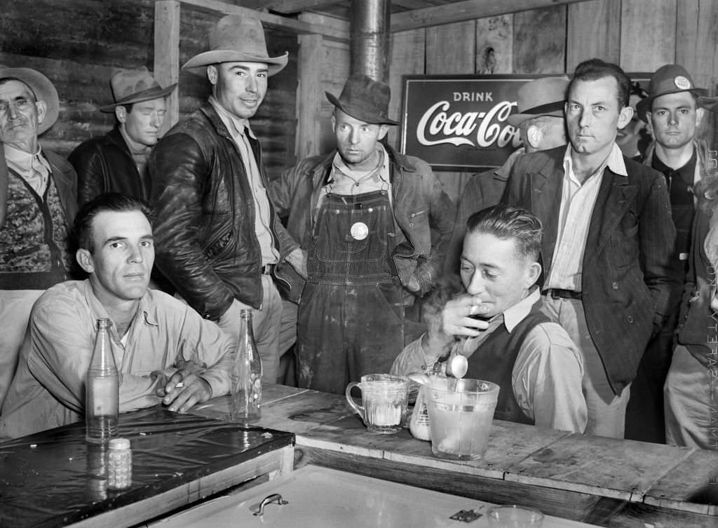 Construction Workers from Camp Livingston U.S. Military Base eating and hanging around new Cafe, Alexandria, Louisiana, December 1940
