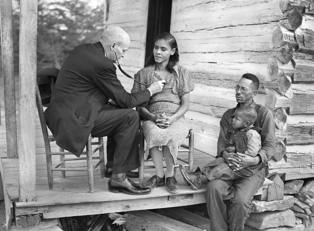 Doctor examining Farmer's Family on Front Porch, Caswell County, North Carolina, October 1940