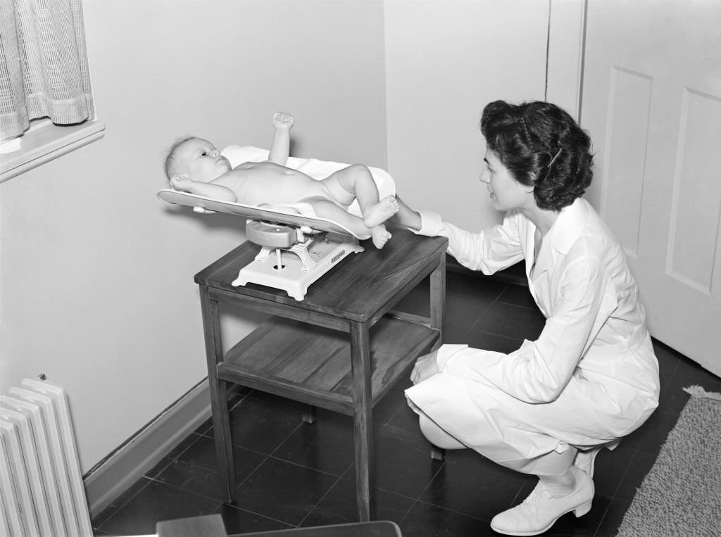 Nurse weighing Baby at Medical Center, Greenbelt, Maryland, August 1939