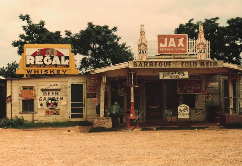 A cross roads store, bar, juke joint, and gas station in the cotton plantation area, Melrose, Louisiana, 1940.