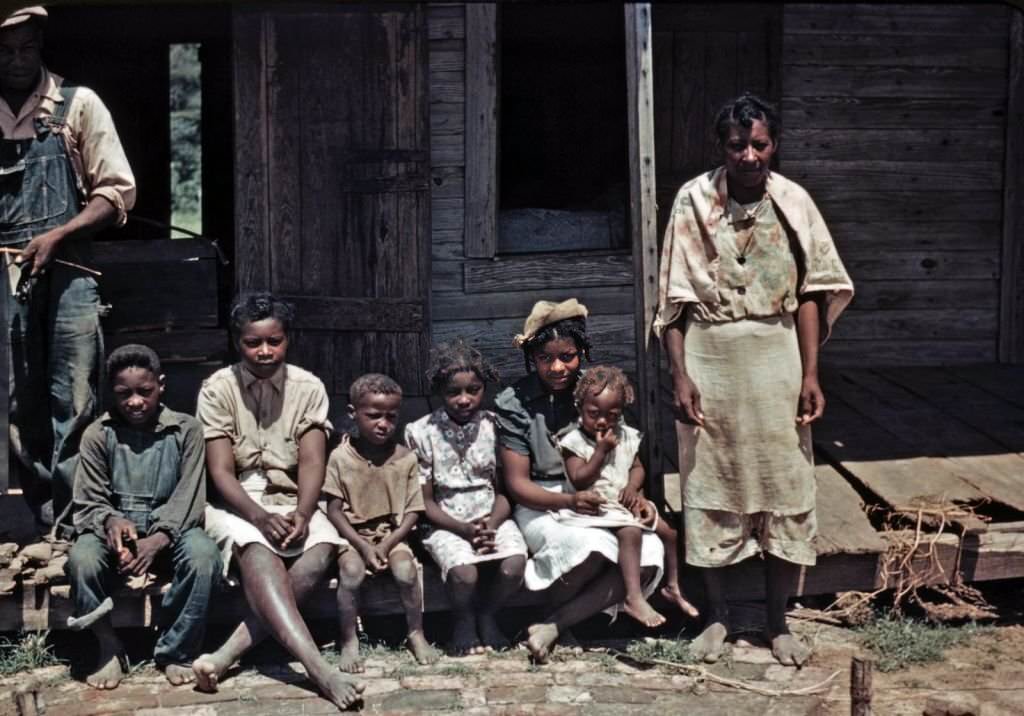A family seated on the porch of a house at the Bayou Bourbeau Plantation, Louisiana, 1940