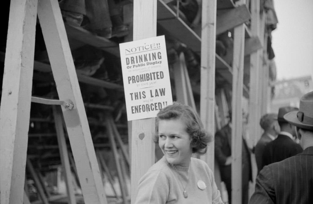 Woman Standing Near No Drinking Sign Posted at Duke University-North Carolina Football Game, 1939