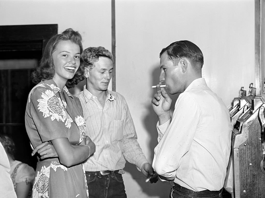 Young Adult Woman and Two Cowboys at Saturday Night Dance, Birney, Montana, August 1941