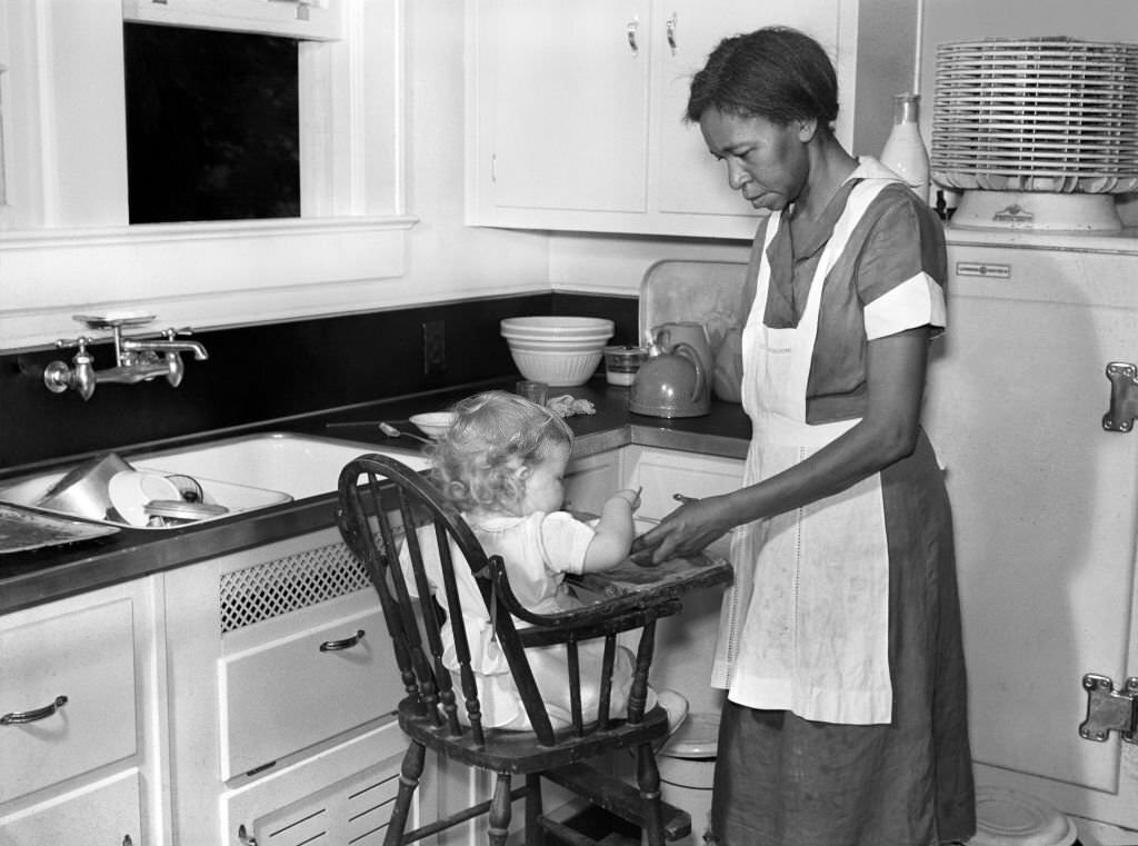 Domestic Worker with Young Child in Kitchen, Atlanta, Georgia, 1939.