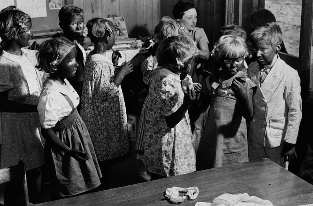 May 1939: A group of young children being made up to take part in a song and dance routine during May Day-Health Day festivities at Ashwood Plantations, 1939