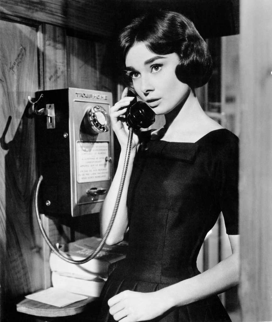 Audrey Hepburn uses a taxiphone in a scene from the Allied Artists film 'Love In The Afternoon', 1957.