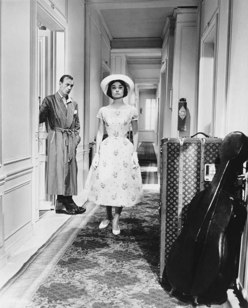 Frank Flannagan (Gary Cooper) watches Ariane Chavasse (Audrey Hepburn) walk down the hallway 'Love in the Afternoon', 1957.