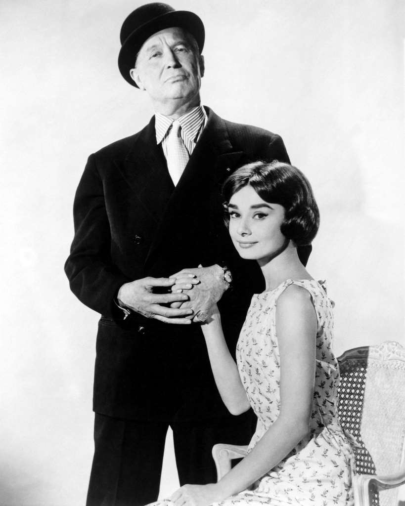 Audrey Hepburn and Maurice Chevalier in a promotional portrait for 'Love In The Afternoon', directed by Billy Wilder, 1957.
