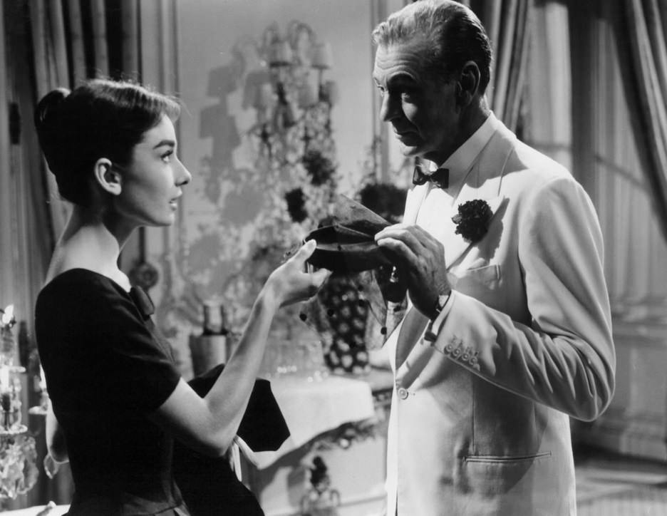 Audrey Hepburn and Gary Cooper holding woman's cap in a scene from the film 'Love In The Afternoon', 1957.