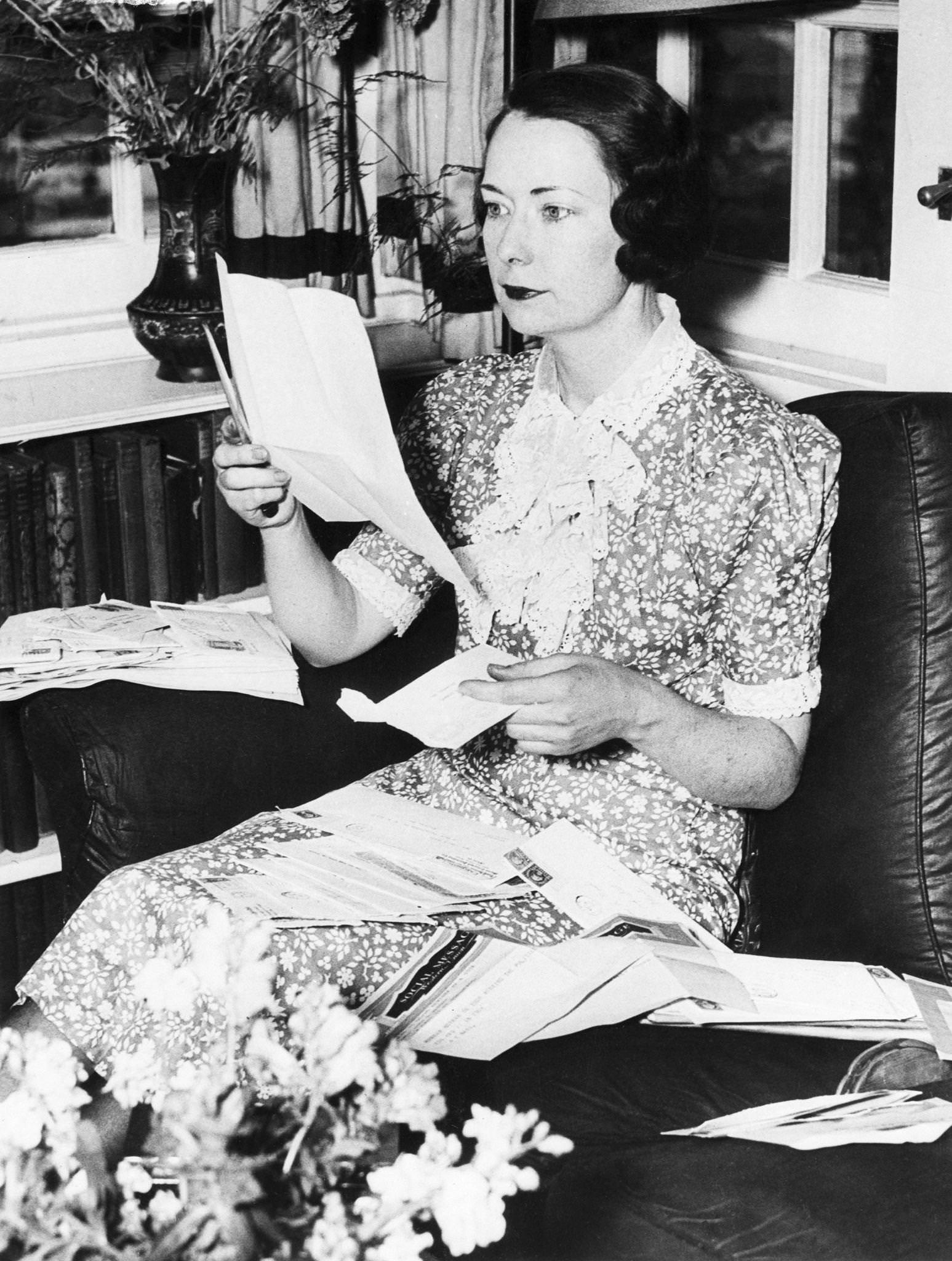Margaret Mitchell reads written and wired congratulations in her home in Atlanta, Georgia, following announcement that the novel had won the Pulitzer Prize.