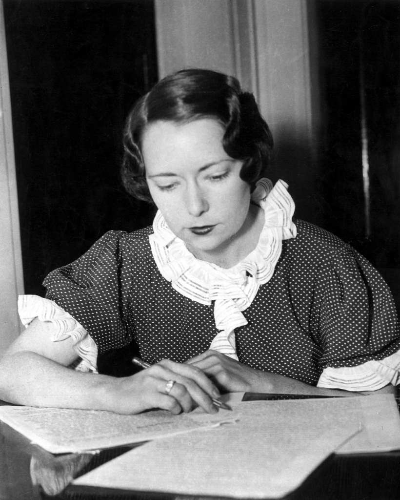 The American writer Margaret Mitchell writing sitting at a table, 1936