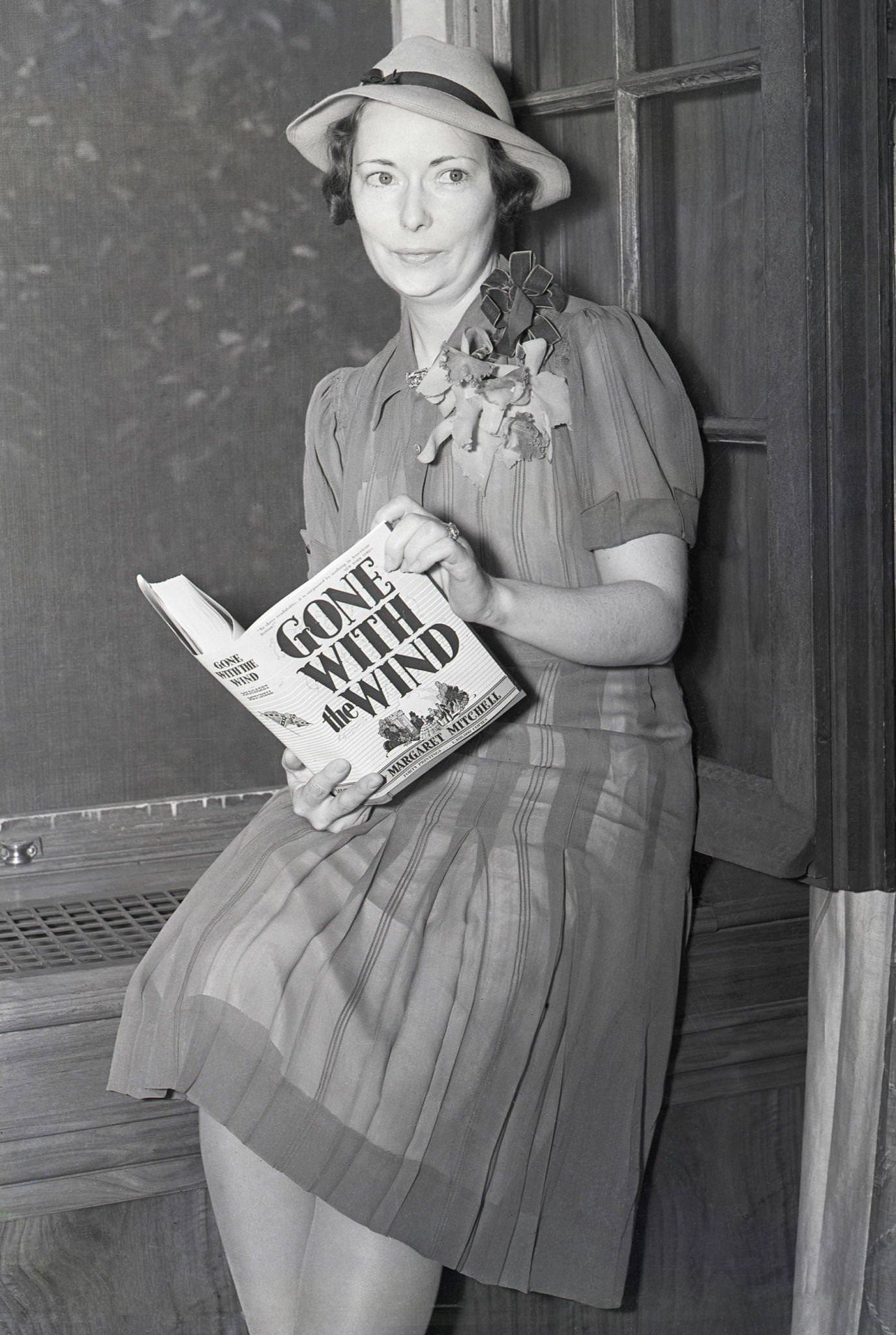 Margaret Mitchell holds a copy of her best-selling novel during her first New York interview at her publishers' office in 1938.