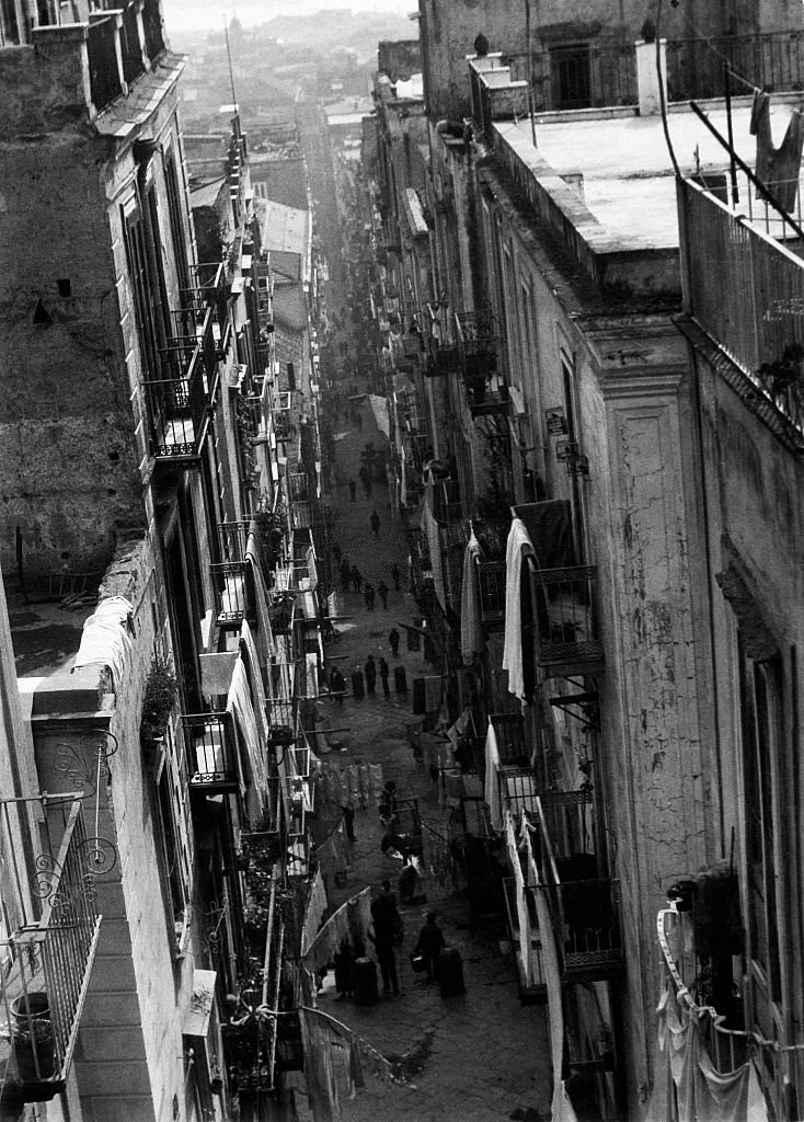 Street scene, a narrow alley with balconies, 1930