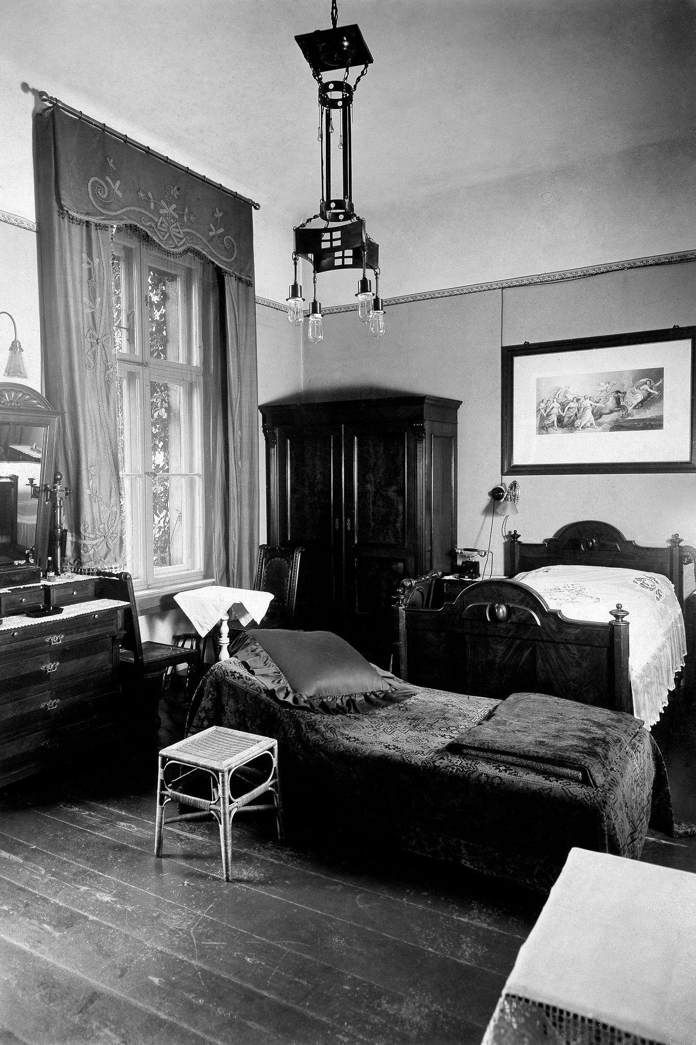 Old fashioned bedroom with 19th century furniture, beds.